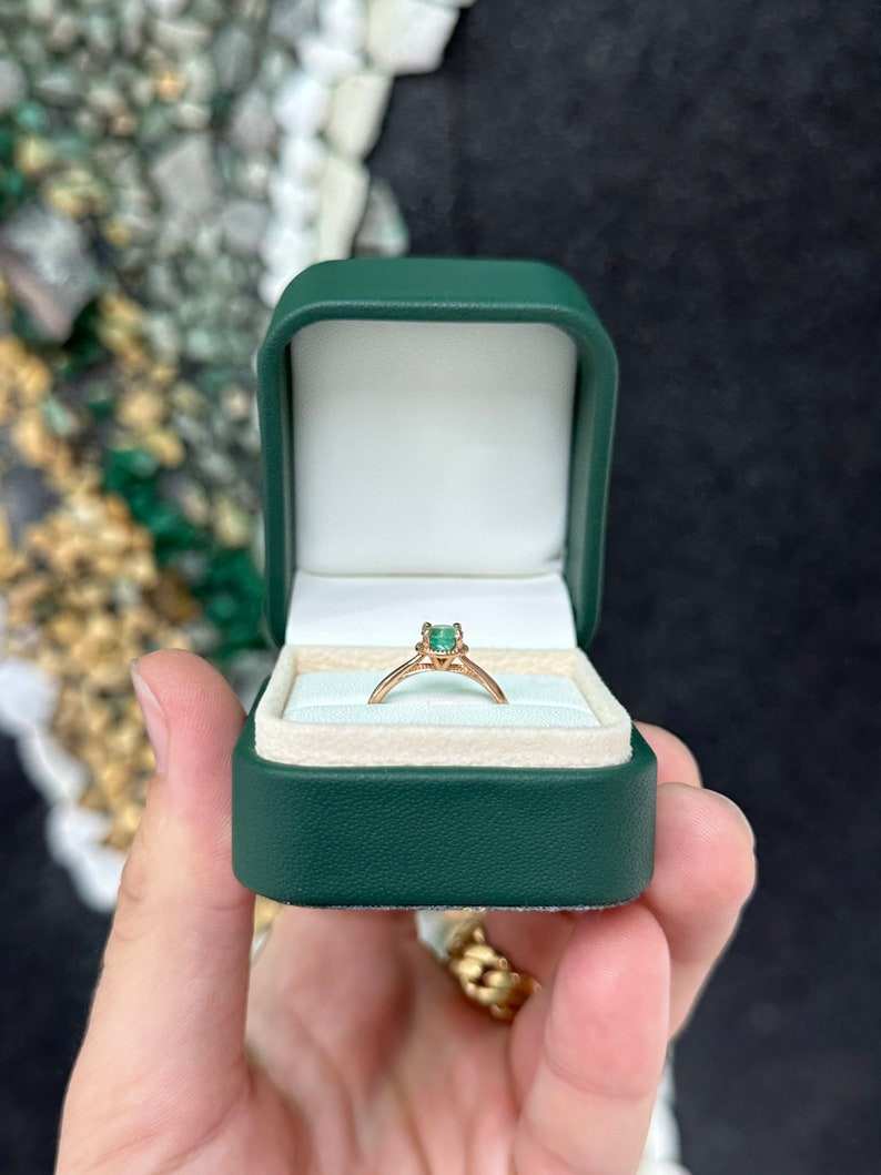 14K rose gold engagement ring with a 0.90ct round cut emerald solitaire, Colombian Emerald brand, right hand ring style.