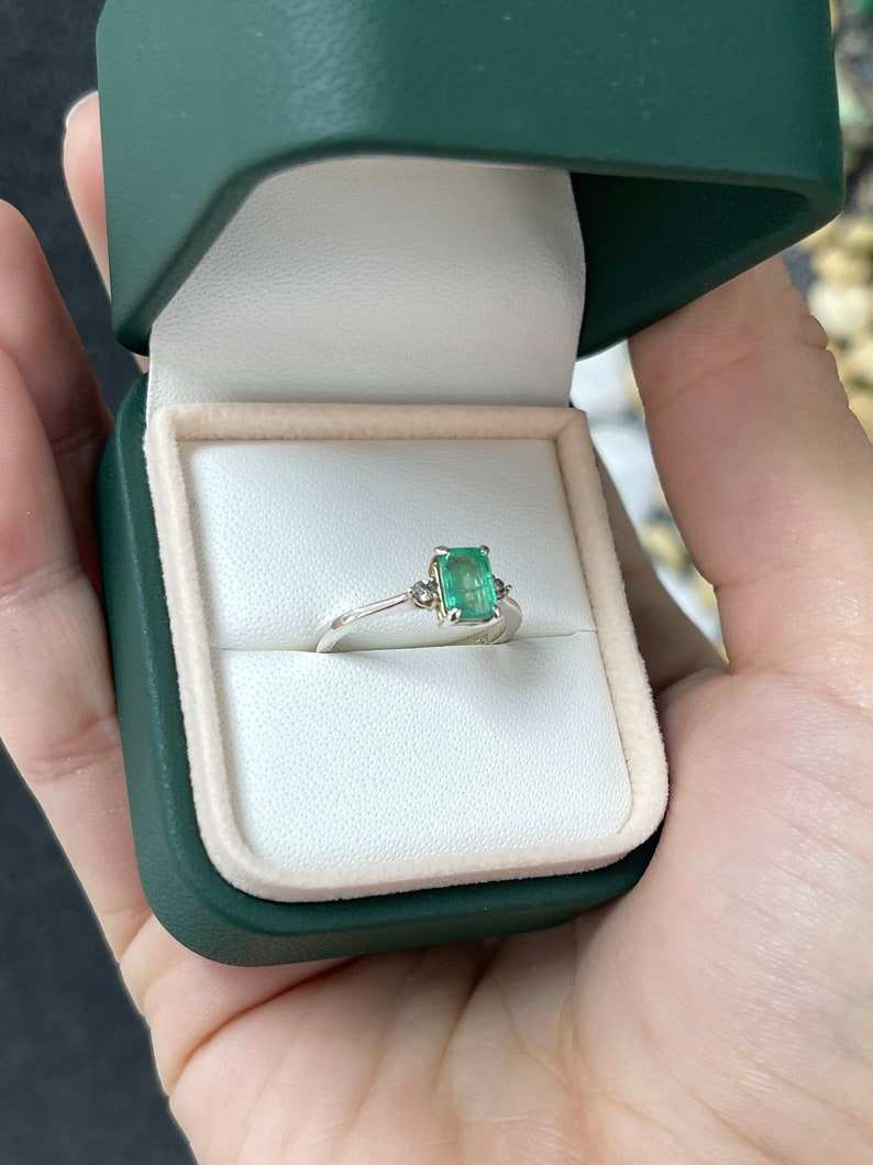 Sterling silver 3-stone ring with 0.98tcw natural medium green emerald cut and round brilliant diamonds, Colombian Emerald brand