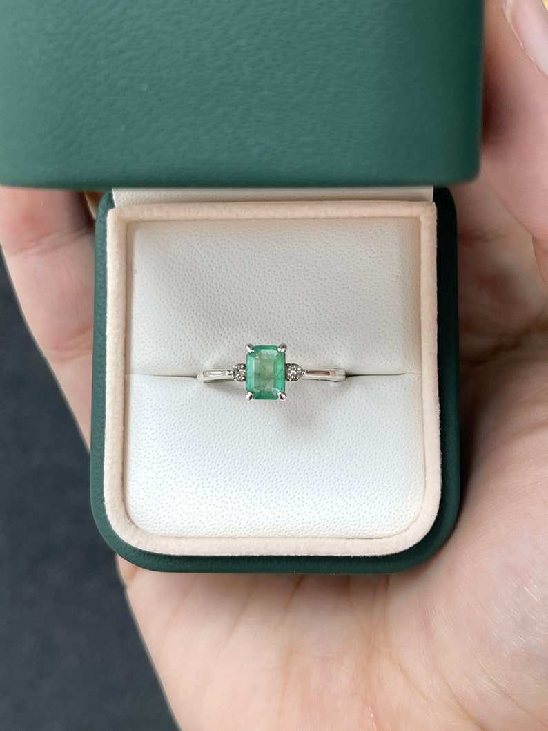 Sterling silver 3-stone ring with 0.98ctw natural medium green emerald cut and round brilliant diamonds, Colombian Emerald brand