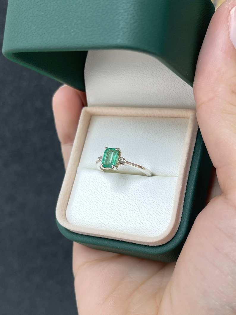 Sterling silver 3-stone ring with 0.98tcw natural medium green emerald-cut and round diamonds from Colombian Emerald.