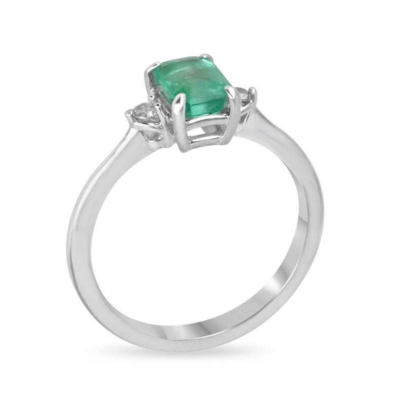 Sterling silver 3-stone ring with 0.98tcw natural medium green emerald cut and round brilliant diamonds, Colombian Emerald brand.