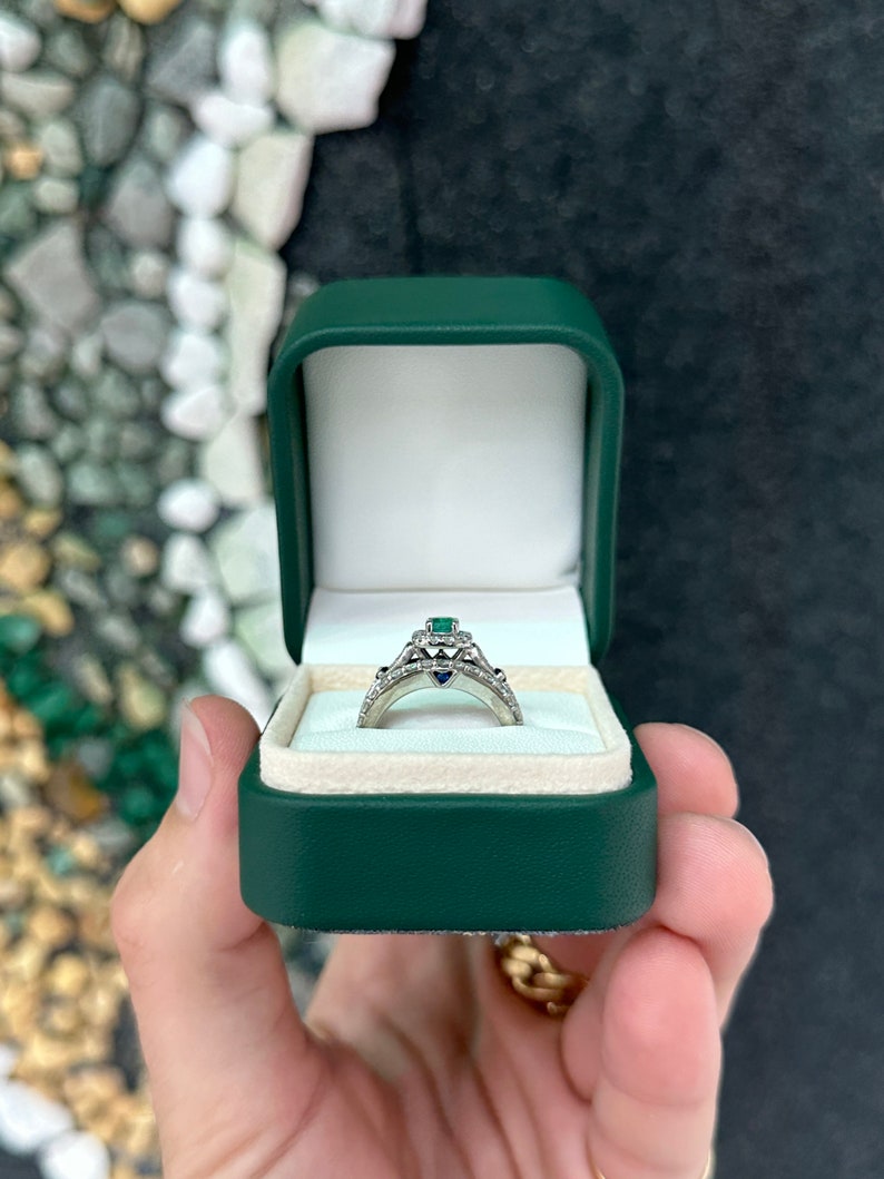 14K gold engagement ring with natural emerald and sapphire accents, featuring intricate design and diamond details by Colombian Emerald