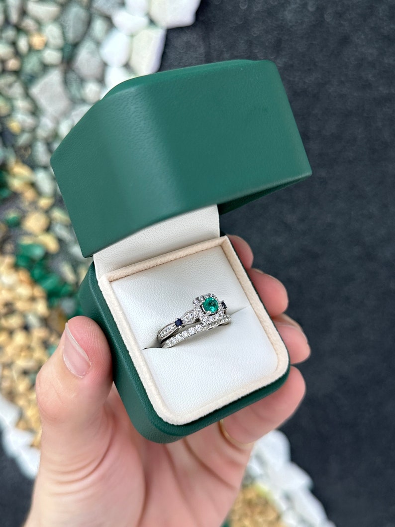 14K gold engagement ring with 1.44tcw natural emerald, sapphire accents, and diamond details from Colombian Emerald.