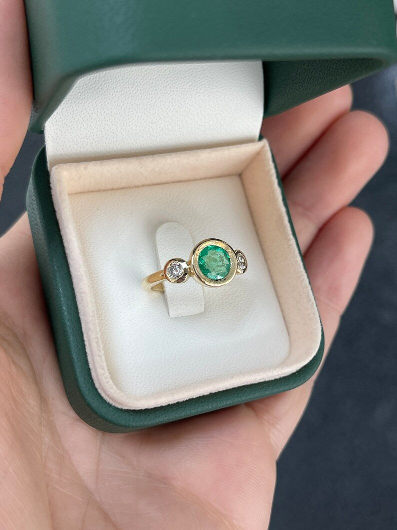 14K gold engagement trilogy ring featuring round cut medium spring green emerald and diamonds by Colombian Emerald.