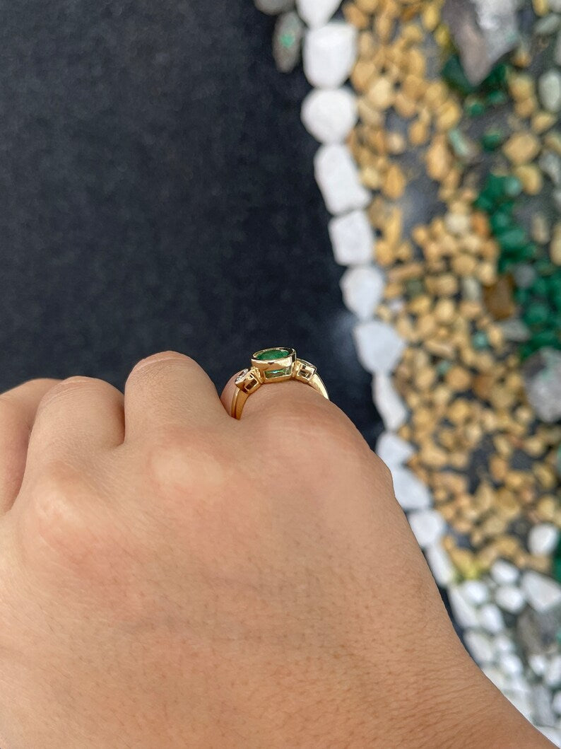 14K gold three stone engagement ring featuring round cut spring green emerald and diamonds by Colombian Emerald.