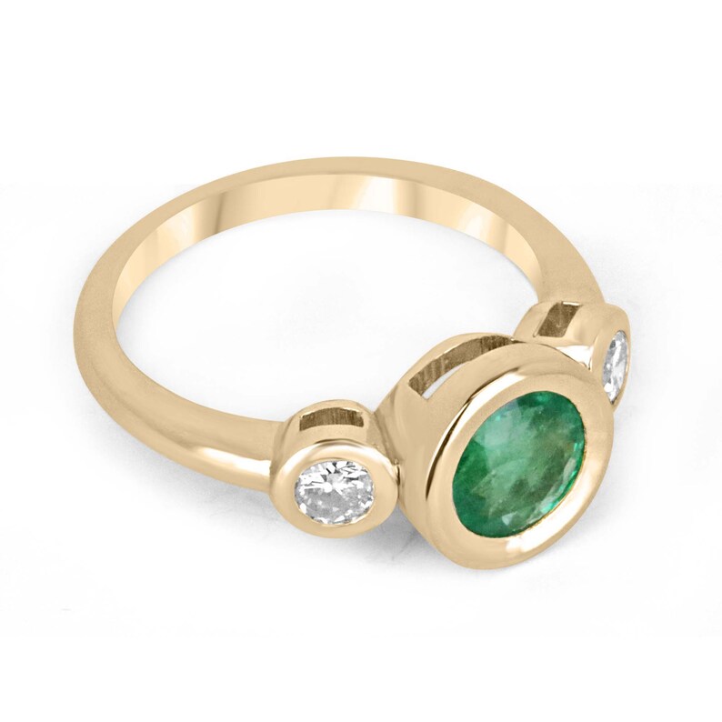 14K gold three stone engagement ring featuring round cut spring green emerald and diamonds by Colombian Emerald.