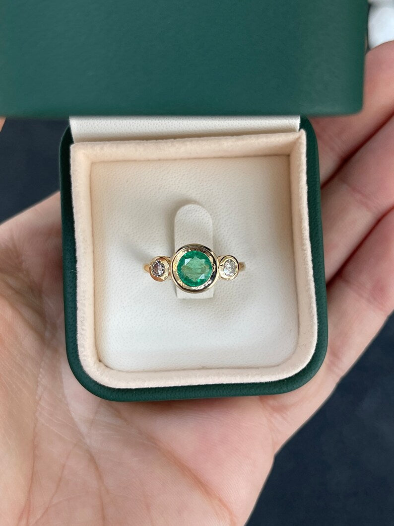 14K gold three stone engagement ring featuring round cut medium spring green emerald and diamonds by Colombian Emerald.
