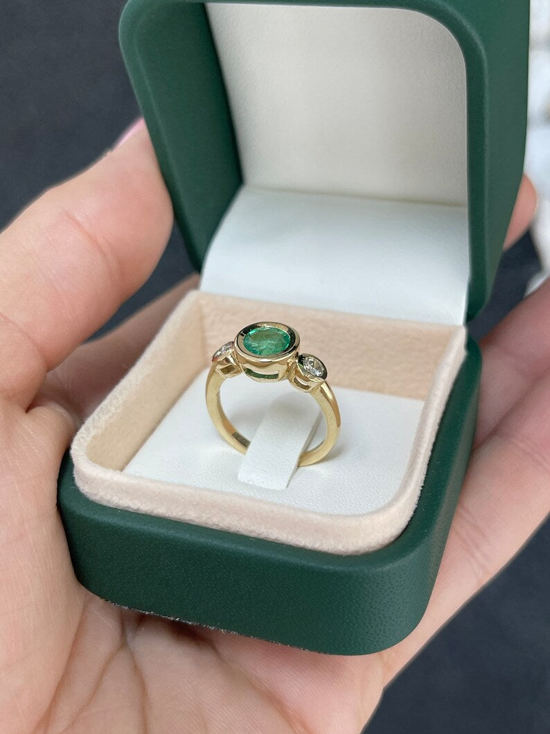 14K gold three stone engagement ring featuring round cut medium spring green emerald and diamonds by Colombian Emerald.