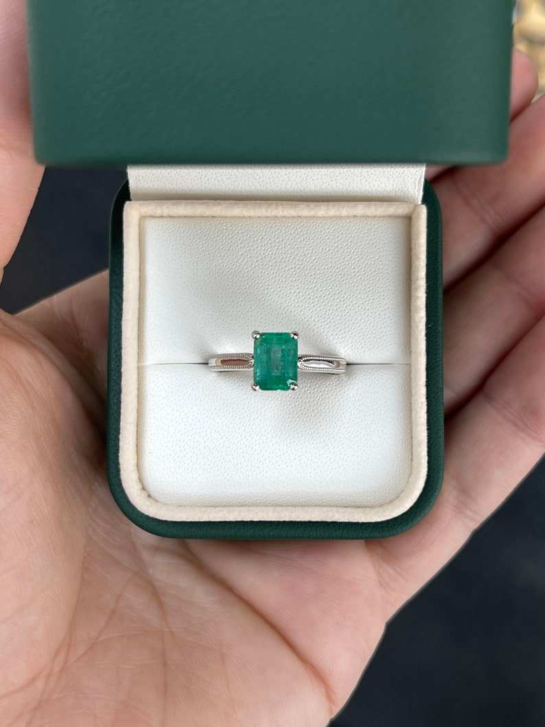 14K Colombian Emerald solitaire engagement ring with a 1.95 carat four-prong emerald centerpiece and classic ring band.
