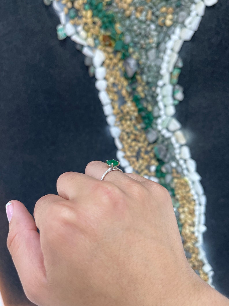 14K white gold engagement ring with a 1.95tcw dark green emerald and diamond accents, featuring a elegant right hand design.