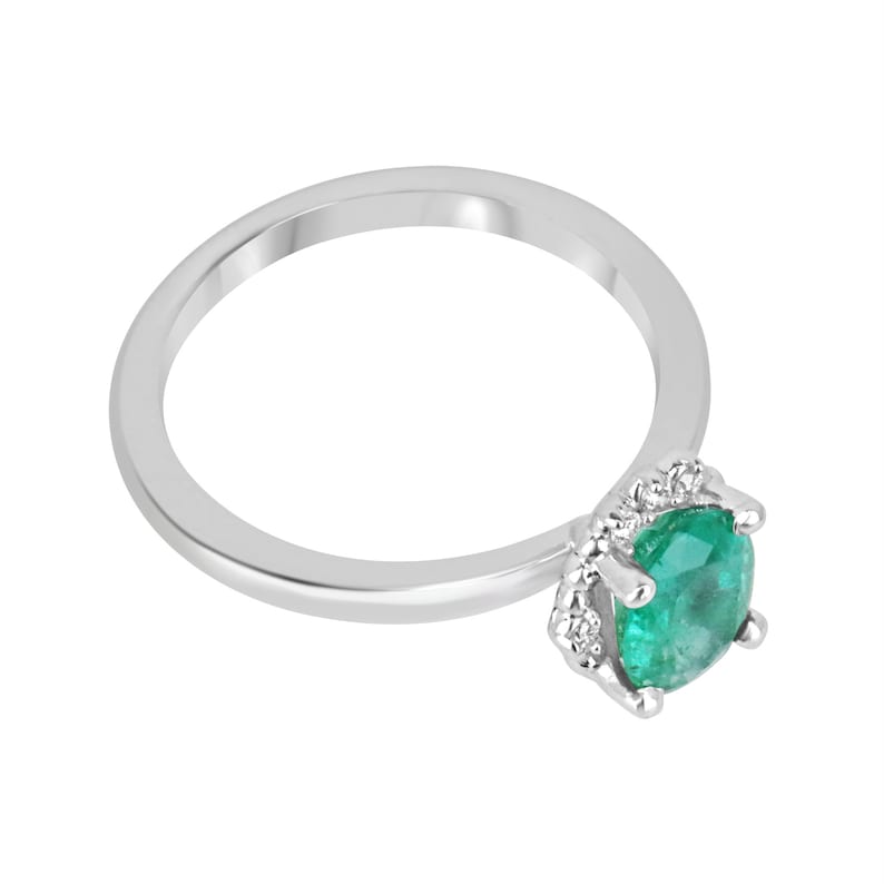 14K gold emerald ring with oval cut emerald centerpiece and petite dark green diamond accents, Colombian Emerald brand.
