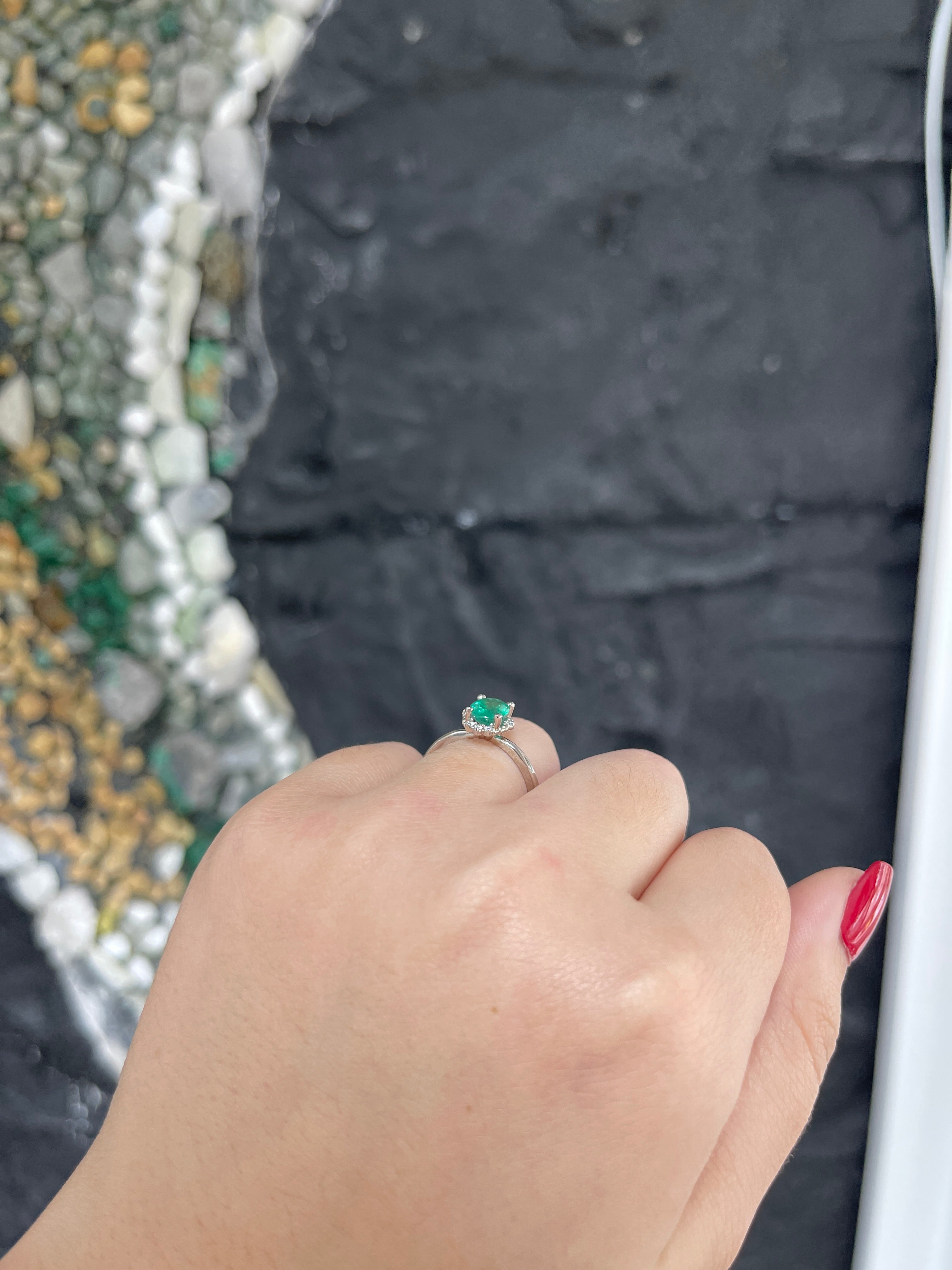 Colombian Emerald gold ring featuring a 1.30tcw oval cut emerald with petite dark green diamond accents in 14K yellow gold.