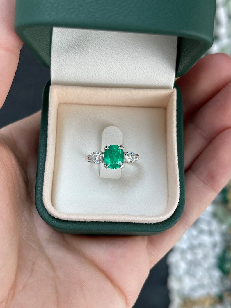 Vivid dark green emerald three-stone engagement ring with diamond accents, set in platinum, from Colombian Emerald.