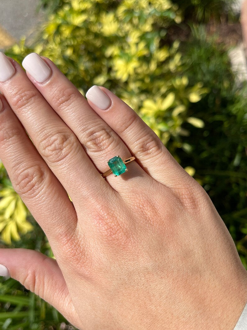 14K gold emerald cut green emerald solitaire ring with four prongs, designed for right hand wear, by Colombian Emerald.