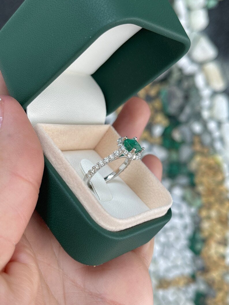 East to West emerald and diamond halo engagement ring in 14K gold with Colombian emeralds and intricate detailing.