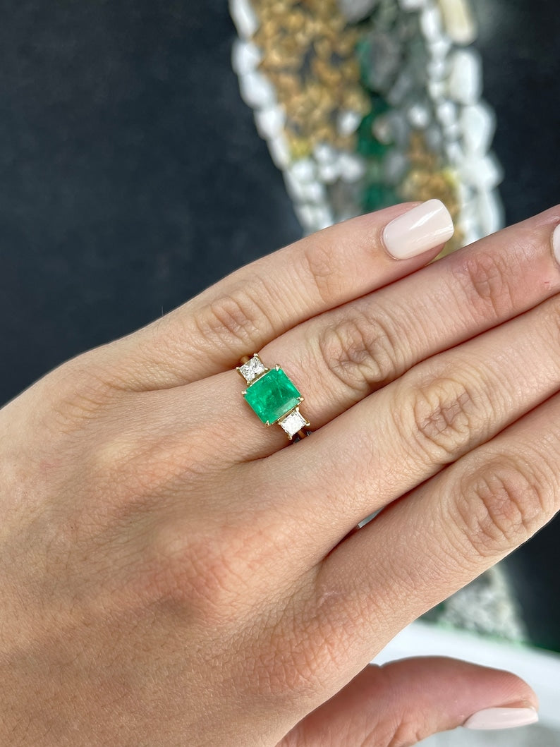 Colombian Emerald and princess cut diamond 3-stone ring in 14K gold, featuring vibrant green emeralds and sparkling diamonds.
