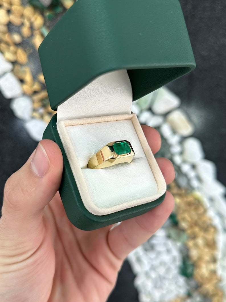 Colombian Emerald 2.70ct AAA+ Vivid Muzo green east-west emerald cut solitaire gypsy ring, showcasing a striking green gemstone.