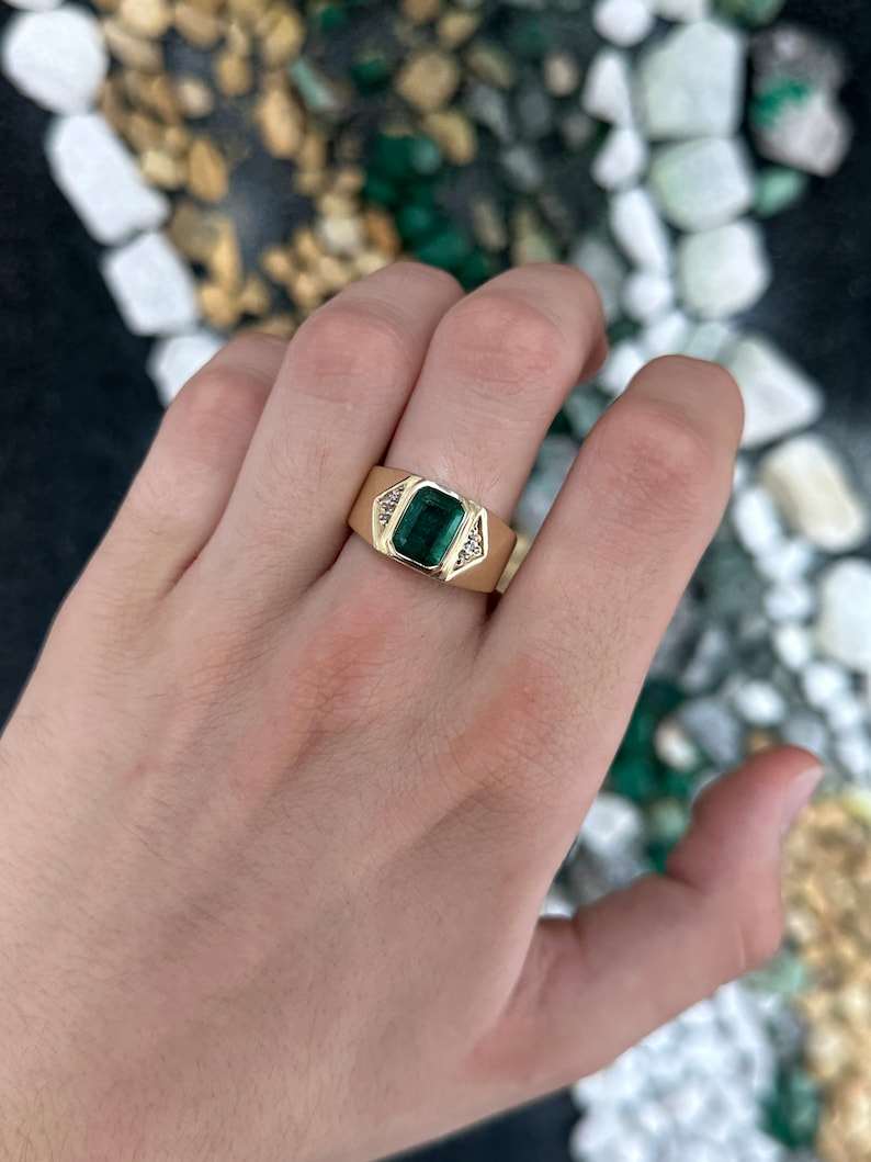 Men's 14K gold emerald cut ring with dark green natural emerald and diamond accents, featuring a 2.73 carat total weight.