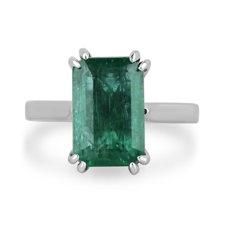 14K gold emerald cut dark green emerald solitaire ring with double claw prongs, featuring a 3.95 carat Colombian Emerald.