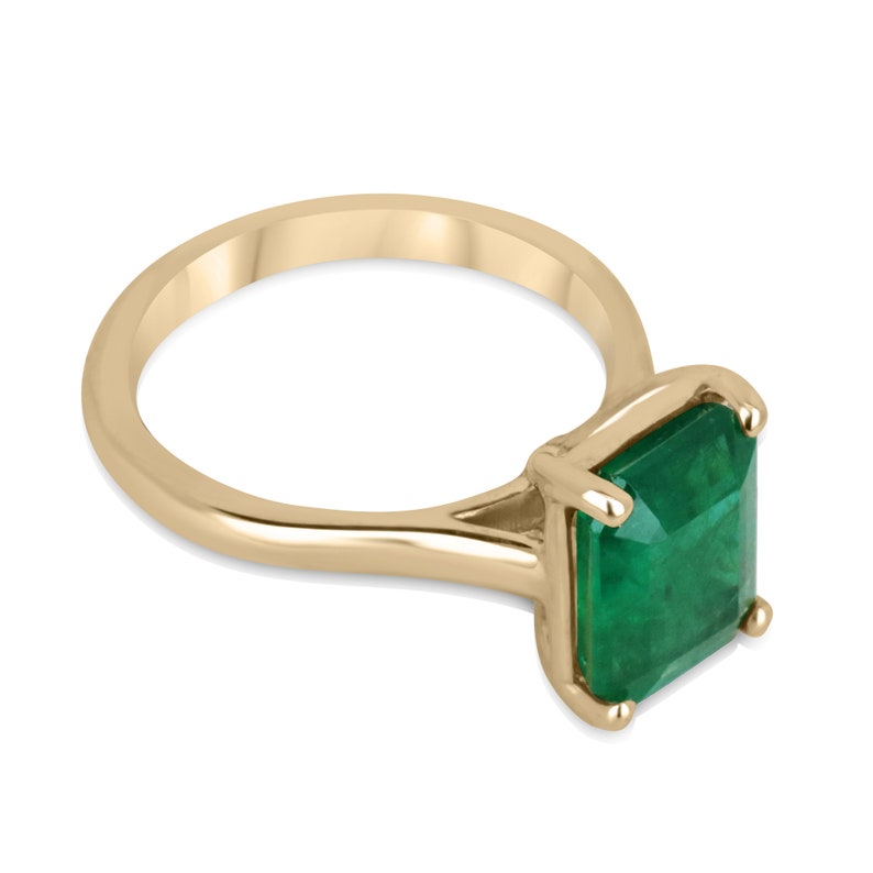 18K gold Colombian emerald solitaire engagement ring with a four-prong setting, showcasing a rich green 3.95ct emerald.