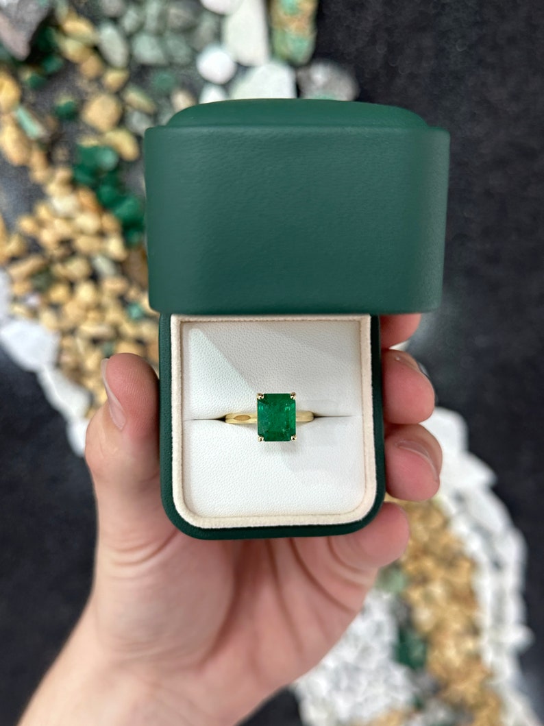 18K gold emerald solitaire engagement ring featuring a 3.95ct rich green Colombian emerald with four prongs on a sleek ring band