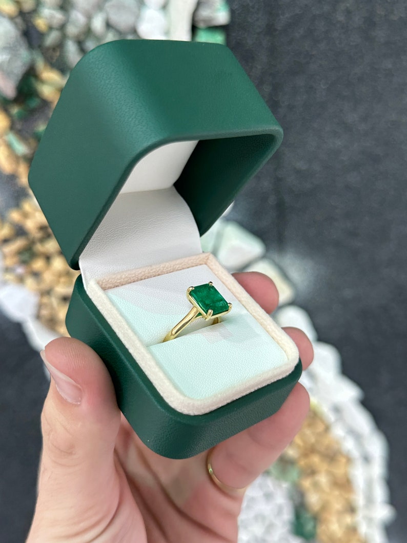 18K gold engagement ring with a 3.95 carat Colombian emerald in a four-prong setting, designed for right hand wear.