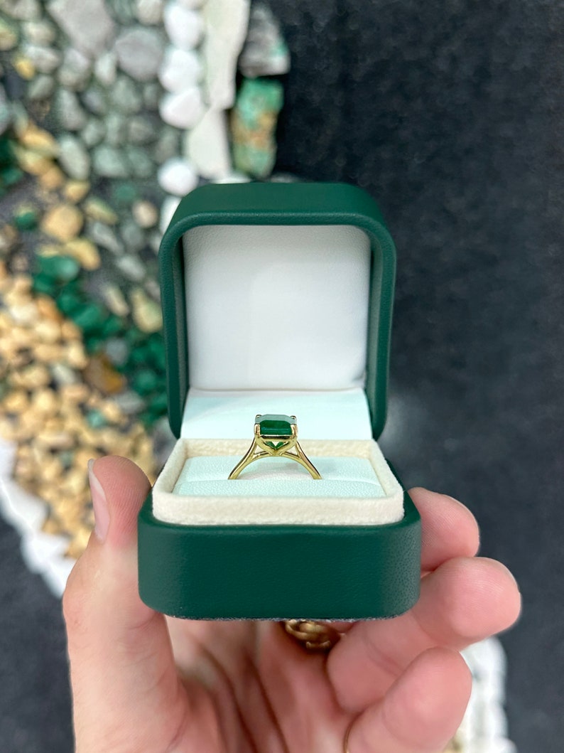 18K gold emerald solitaire ring featuring a rich green 3.95ct Colombian emerald with four prongs for right hand wear.