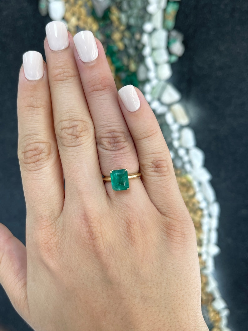 14K gold green emerald cut solitaire engagement ring with 4 prongs and 4.08ct Colombian emerald gemstone.