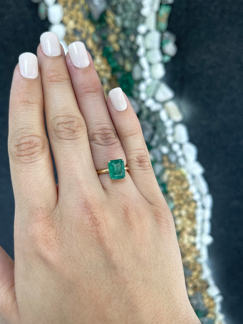 14K gold engagement ring with a 4.08ct rich green emerald cut solitaire emerald, held by 4 prongs, from Colombian Emerald.