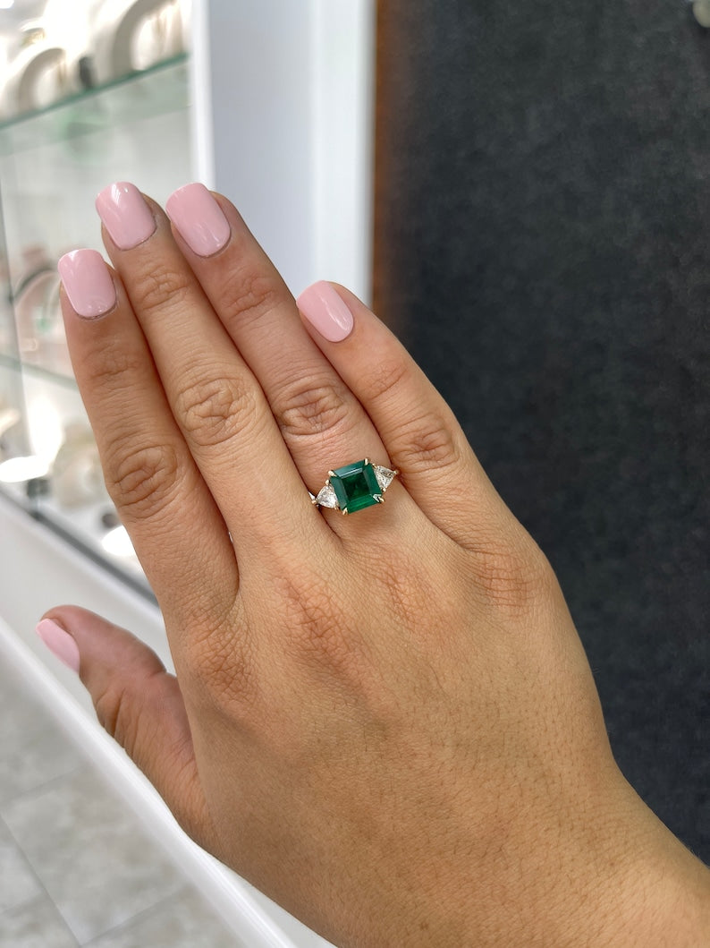 Colombian Emerald 14K gold engagement ring with natural trillion and asscher cut emeralds and diamonds, three-stone design.