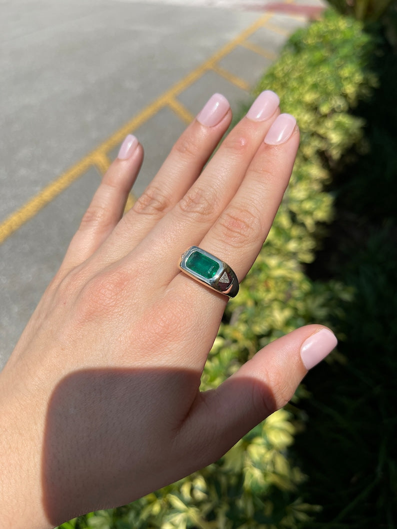 14K gold three-stone ring with rich green emeralds and diamonds in a triangle design, featuring east-to-west setting.