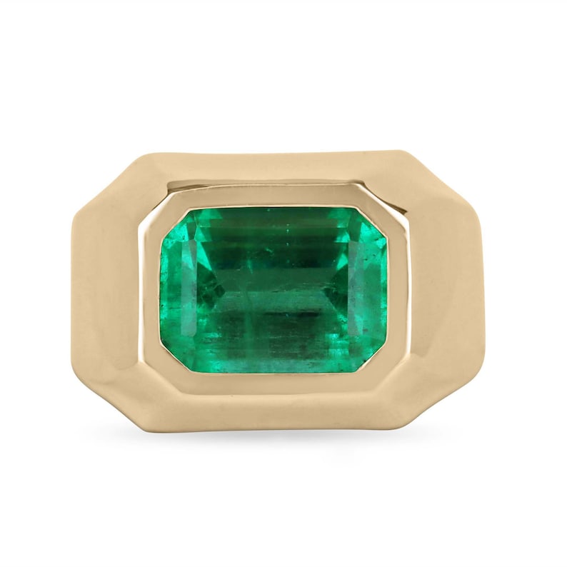 Men's 18K gold right-hand ring featuring a 4.25 carat emerald cut Colombian emerald solitaire gemstone.