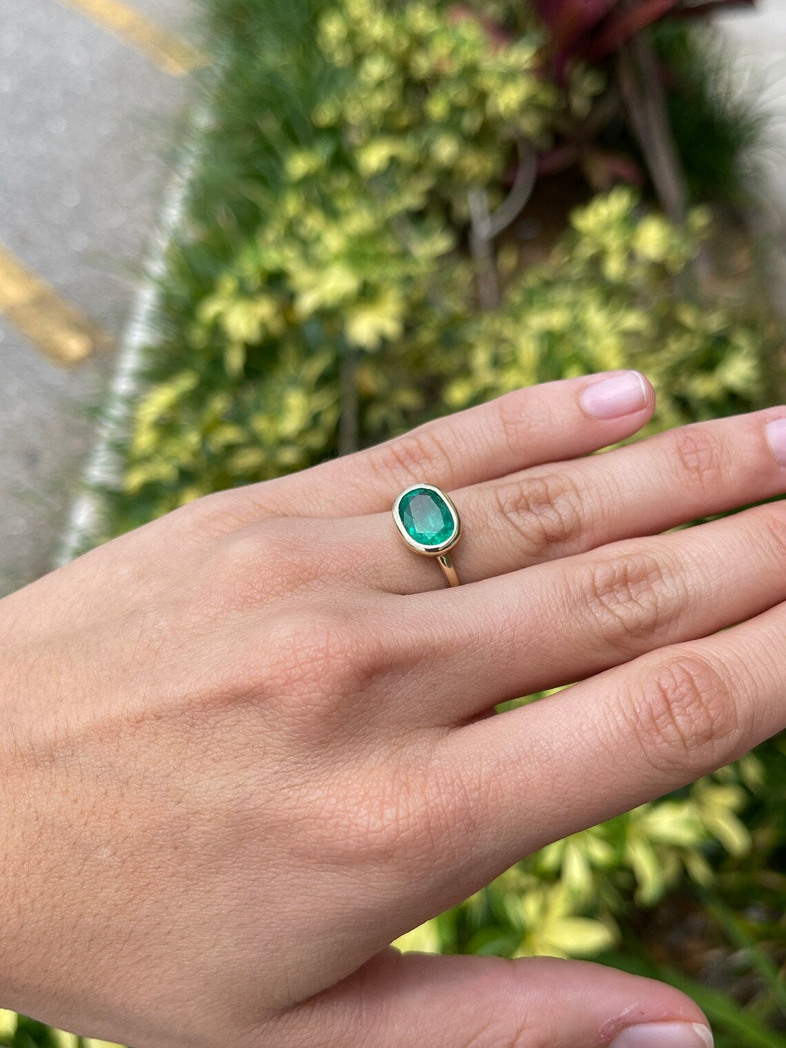 14K gold oval emerald solitaire ring with bezel setting, featuring a rich green east-west design by JR Colombian Emeralds.