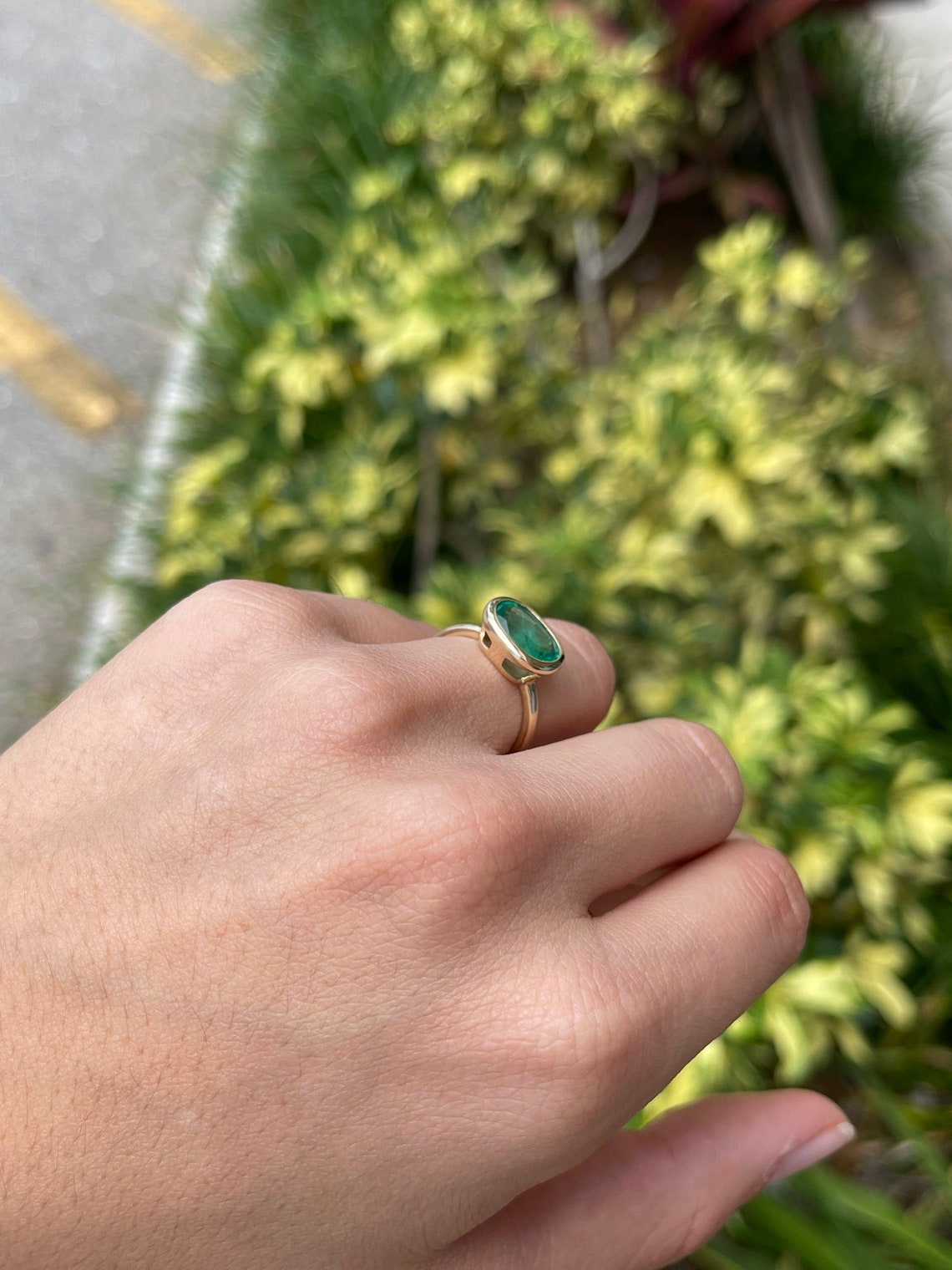 14K gold oval emerald solitaire ring with east-west bezel setting, featuring a rich green Colombian emerald by JR Colombian Emeralds