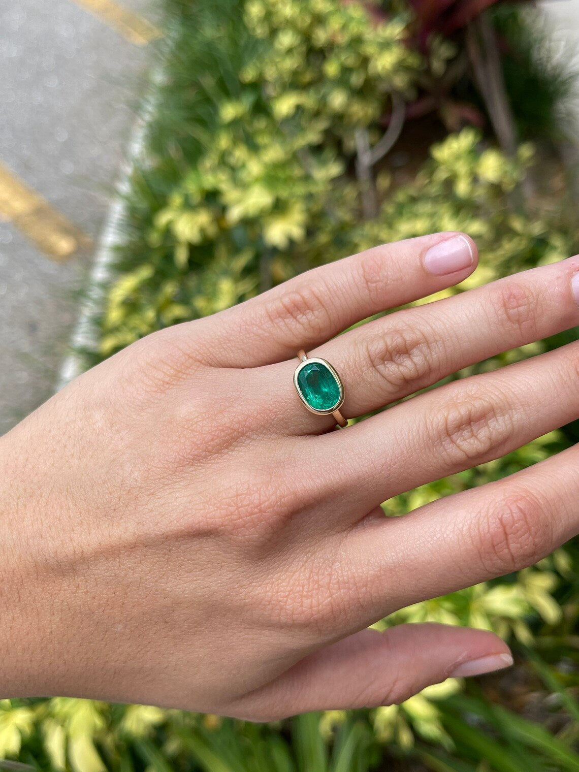 14K gold oval emerald solitaire ring with bezel setting, rich green color, east-west design by JR Colombian Emeralds
