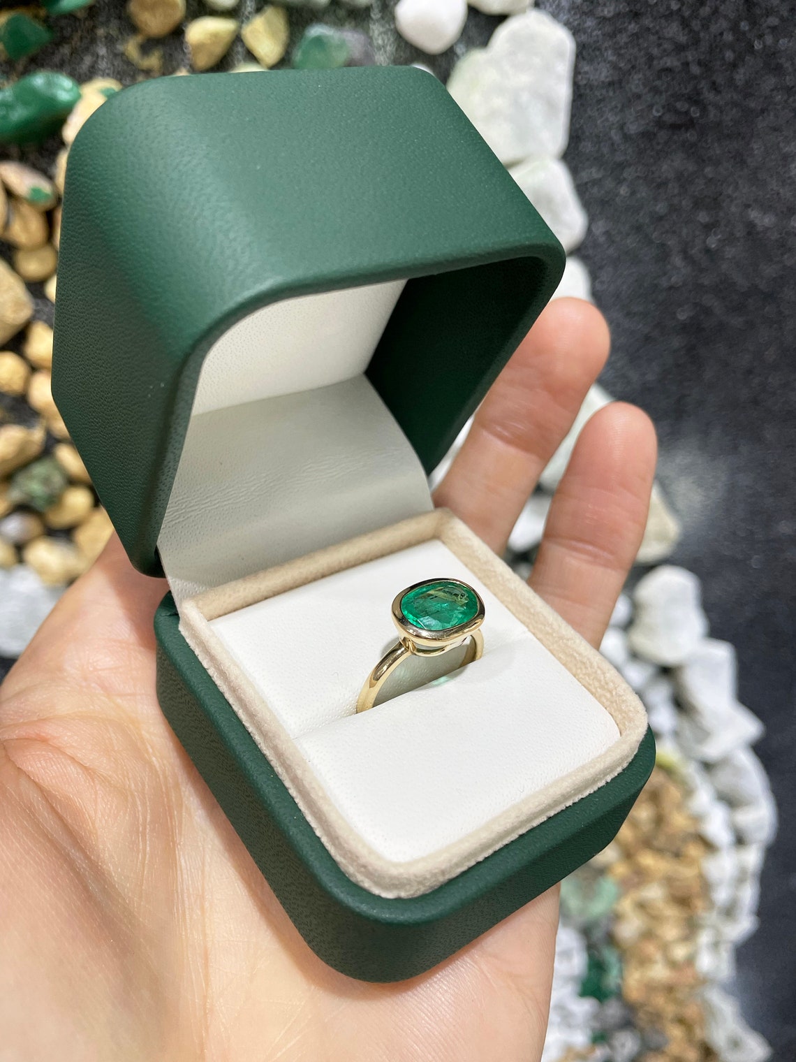 14K gold oval emerald solitaire ring with bezel setting showcasing a rich green east-west gemstone by JR Colombian Emeralds