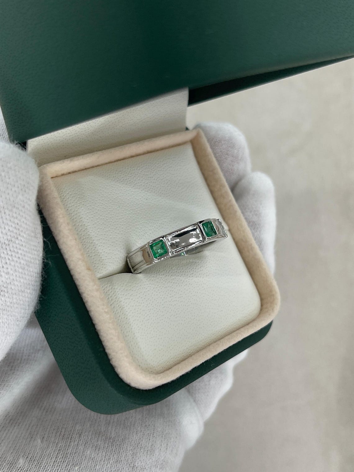 Men's 14K gold emerald three-stone band ring with rich green princess-cut emeralds by JR Colombian Emeralds.