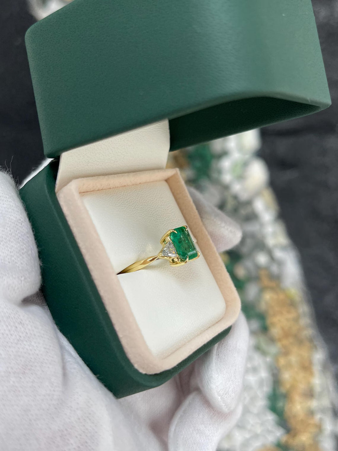 2.37 Carat Emerald Cut Emerald Features Trillion Diamond Side Stones