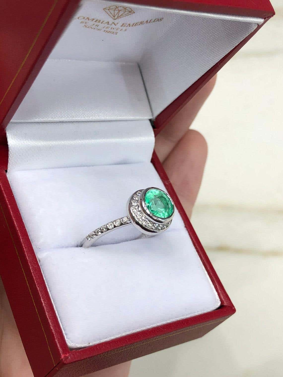 Round 1.60 carat Colombian emerald diamond halo engagement ring in 14K gold, featuring a vibrant green emerald centerpiece.