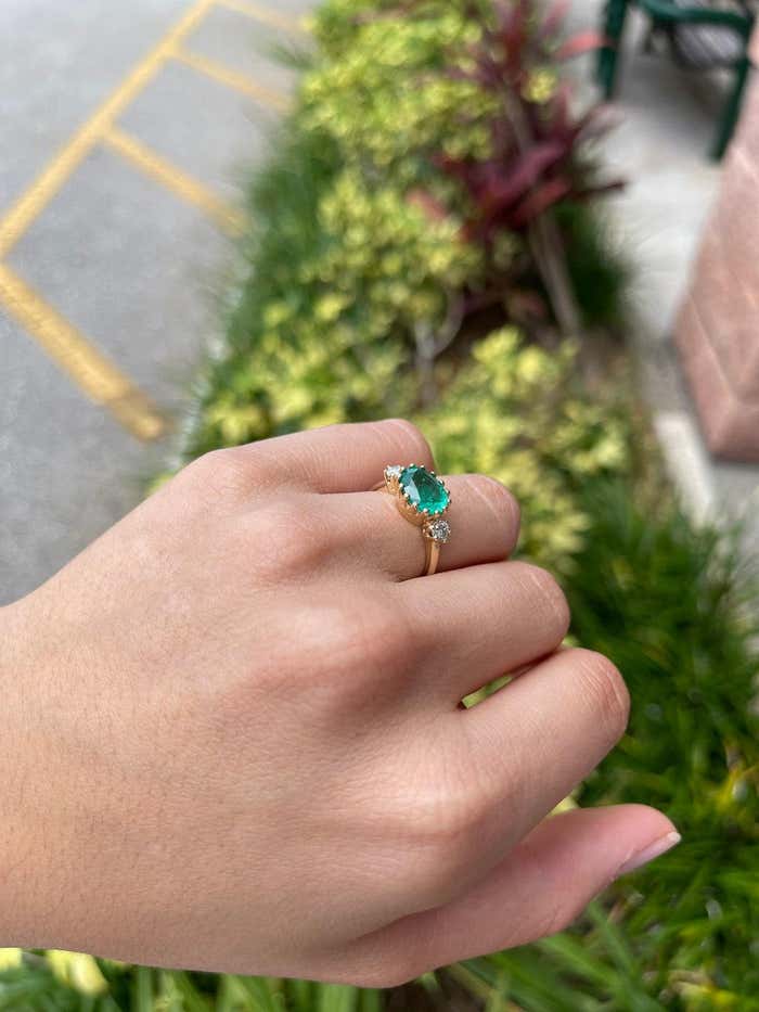 14K gold solitaire ring with a 2.60 carat oval emerald and diamonds, classic green three-stone prong design by JR Colombian Emeralds
