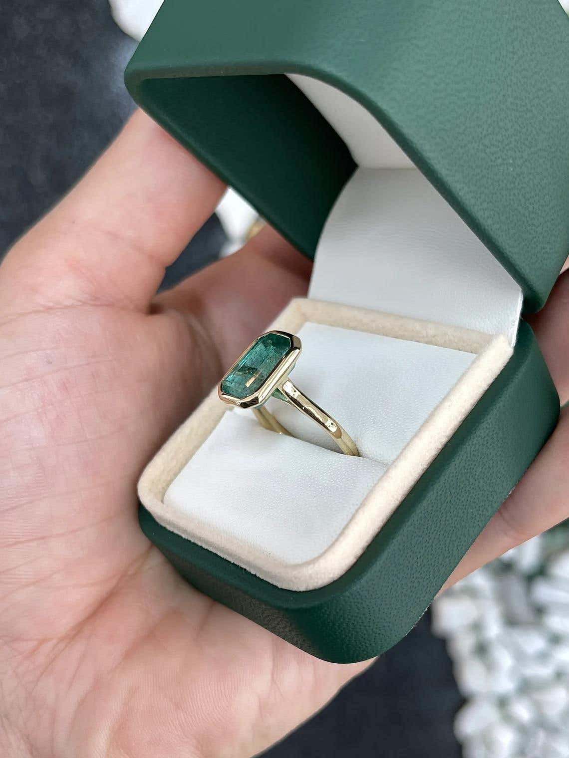 14K gold emerald cut bezel solitaire engagement ring featuring a 4.76ct natural blue-green emerald by JR Colombian Emeralds