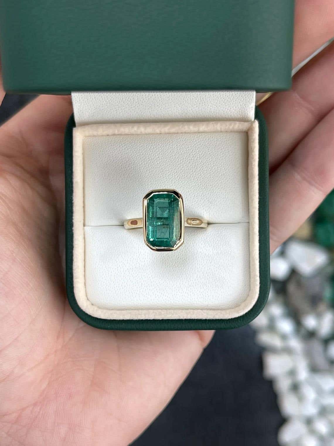Natural emerald engagement ring featuring a 4.76 carat emerald cut bezel-set emerald, 14K gold, blue-green color by JR Colombian Emeralds.