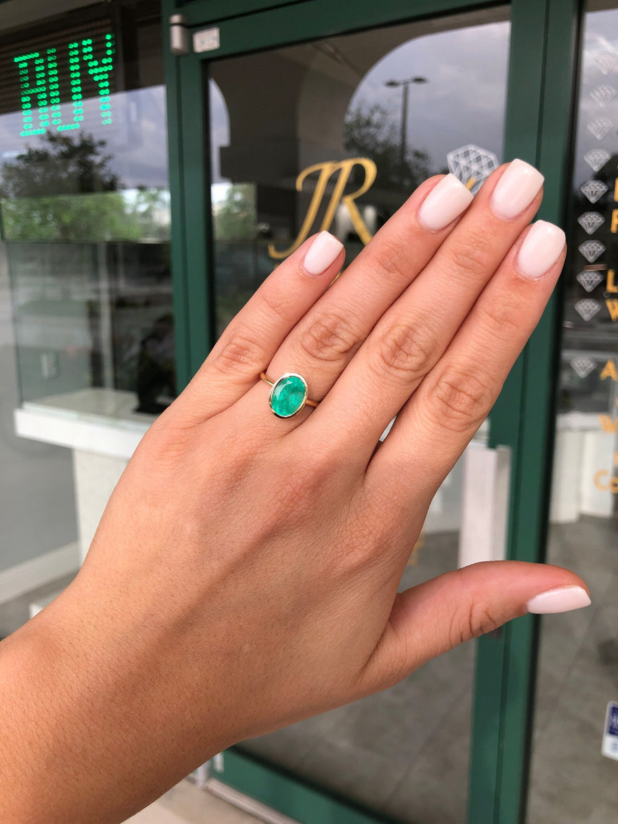 Chic and Sophisticated: Bezel Set Oval Emerald Solitaire 3.0 Carat Ring in 14K Gold with Open Basket