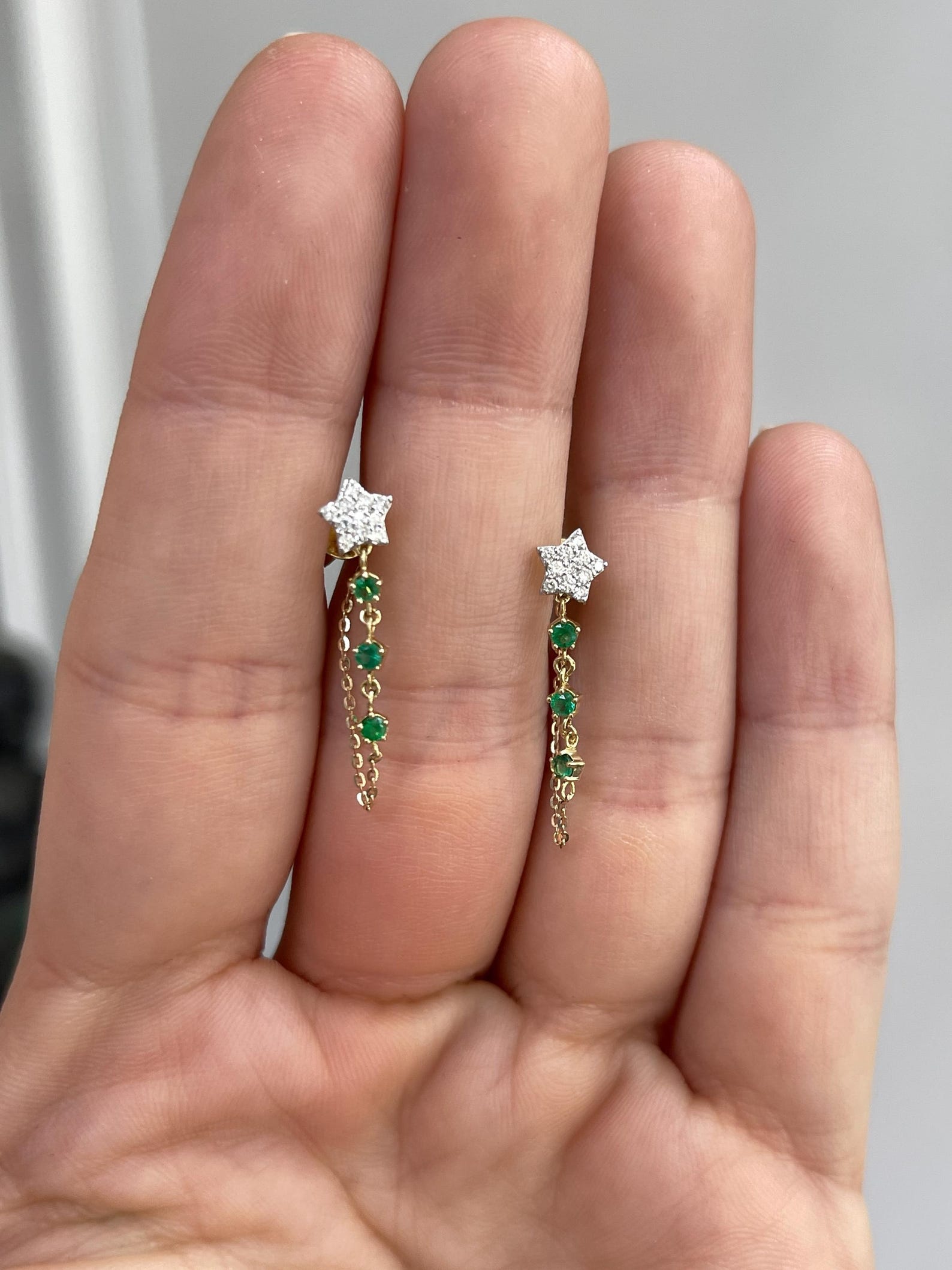 JR Colombian Emeralds 0.36 Carat diamond star dangle earrings in 14K gold with rich green emeralds and sparkling diamonds.