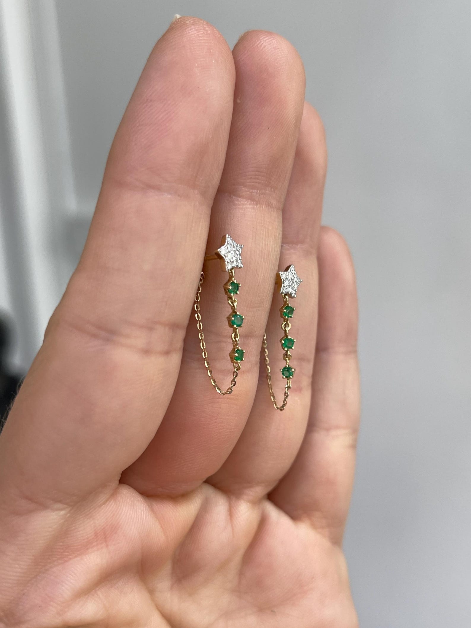 JR Colombian Emeralds 0.36 Carat emerald diamond star dangle earrings in 14K gold with rich green gemstones.