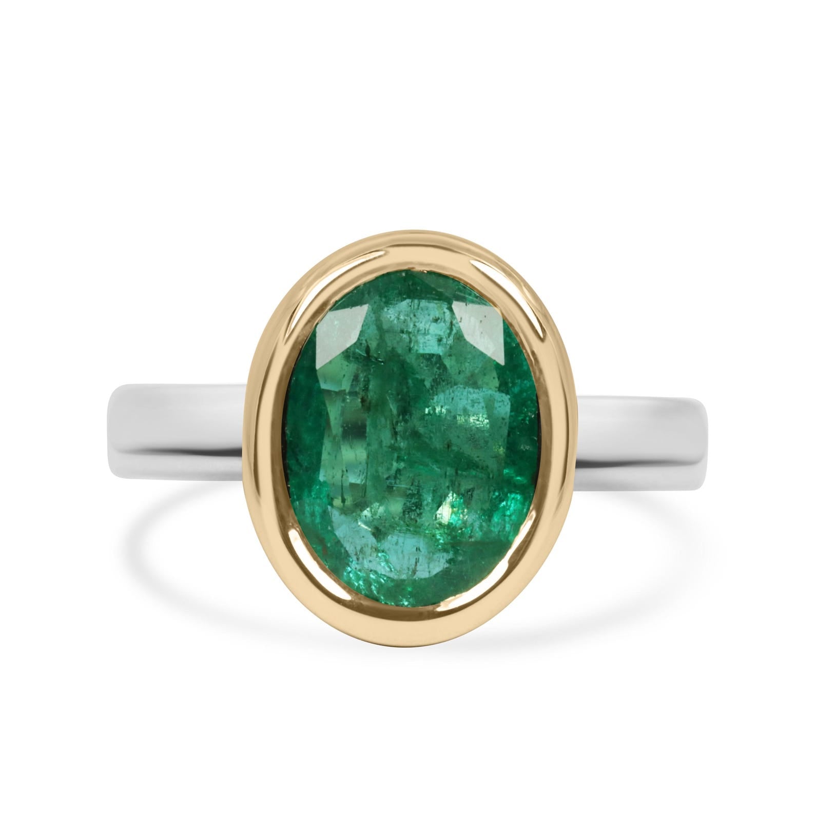 3.85 carat oval emerald solitaire ring in two‑toned 14k gold bezel setting