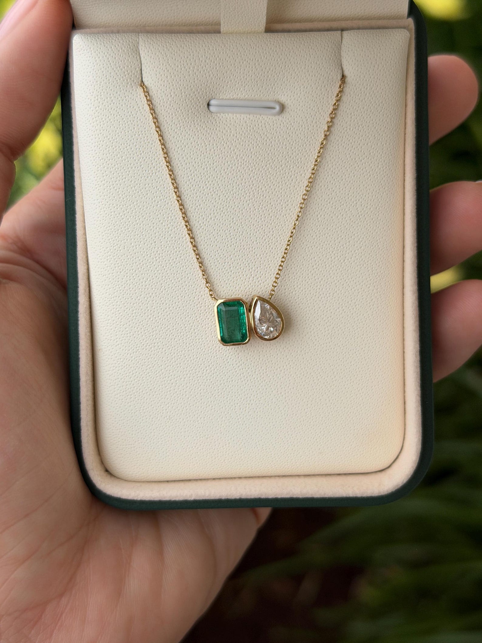 Emerald moissanite pendant necklace featuring two stones in a toi et moi style, crafted by JR Colombian Emeralds.