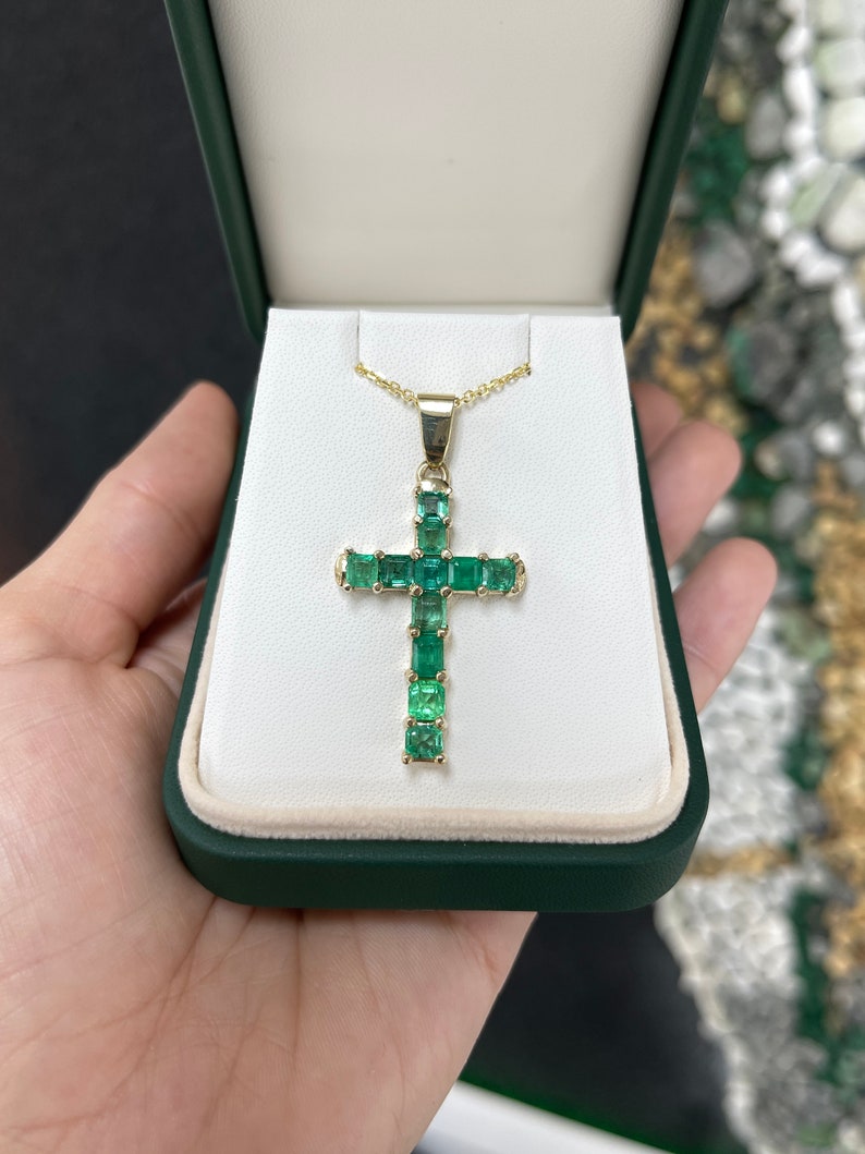 Elegant 14K Gold Cross Pendant featuring 11 Asscher Cut Emeralds in a Medium Dark Green Shade
