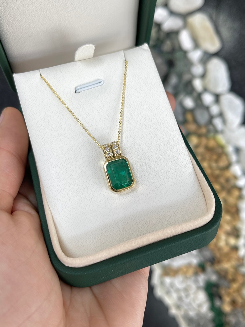 Elegant 18K Gold Pendant Showcasing a 4.69tcw Natural Emerald in Bezel Setting with Pave Diamond Highlights
