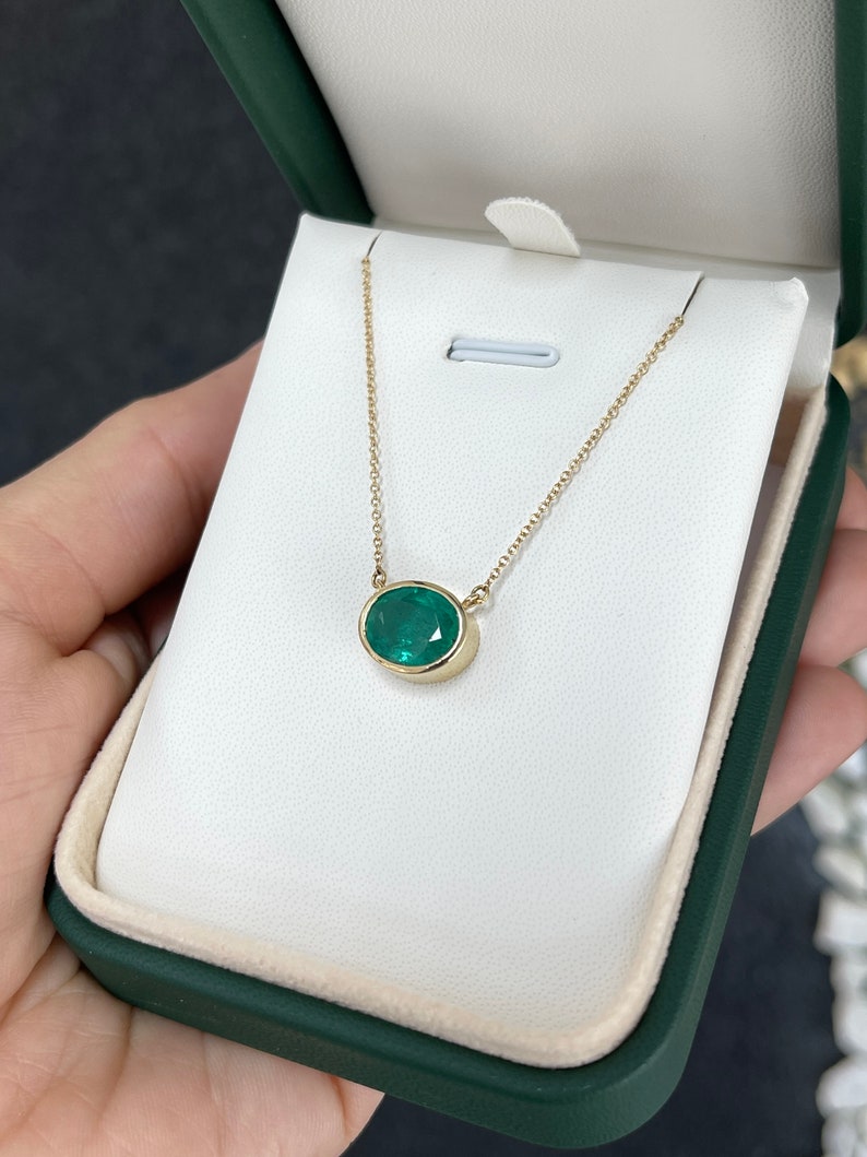 14K Gold East-West Pendant Necklace Highlighting a 3.20ct Oval Emerald in Luxurious Green